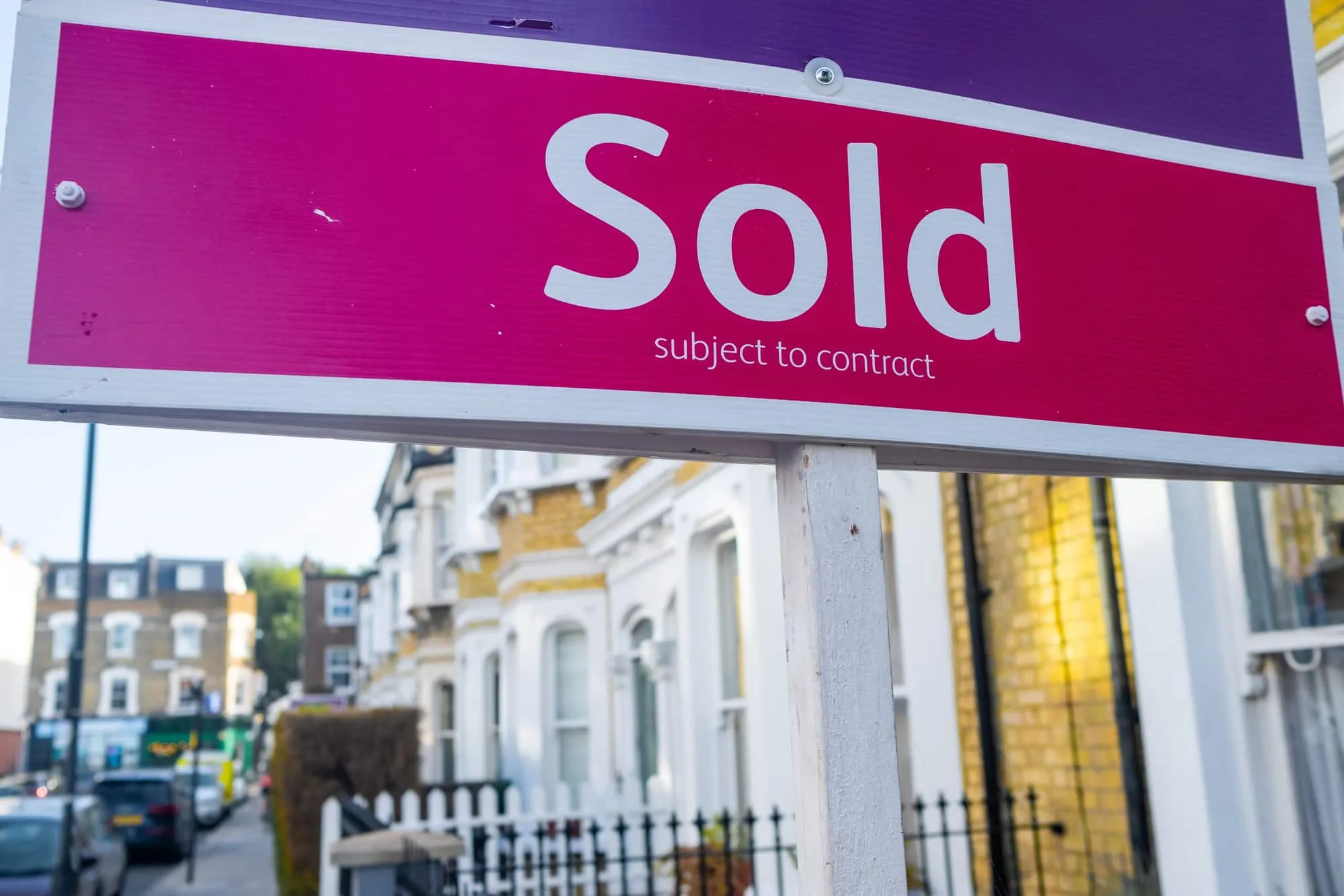 Sold Subject To Contract Sign Sold subject to contract sign outside a row of houses.